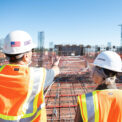 Construction workers looking at a job site - Touchplan